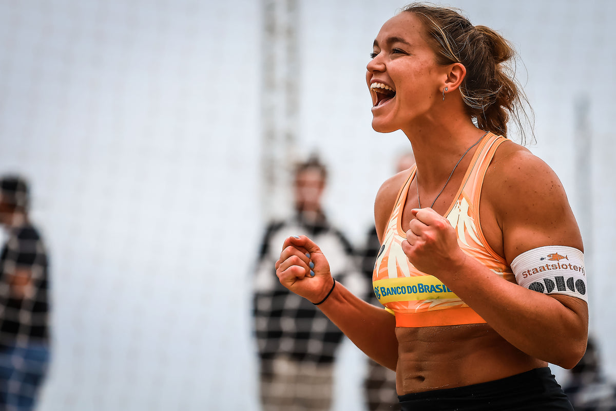 Emi van Driel laughing on the beach volleyball court