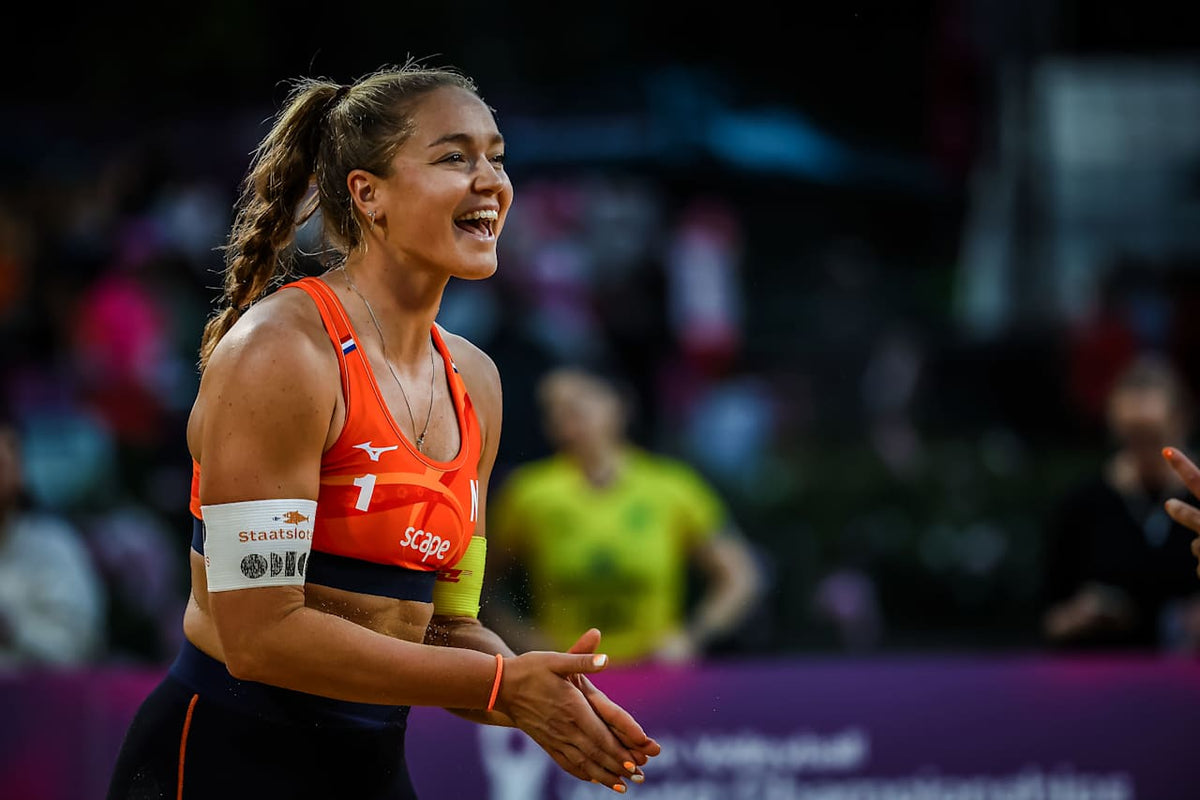 Emi van Driel smiling on court at a beach volleyball tournament